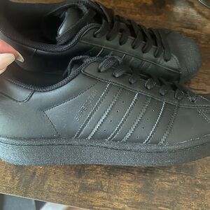Adidas black on black shell top sneakers.